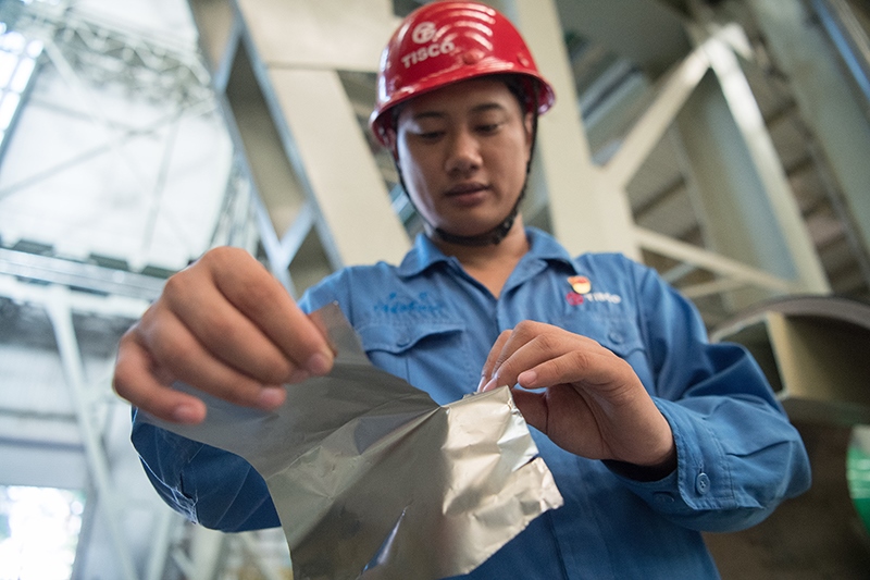 2018年8月8日，山西省太原市，太鋼不銹鋼精密帶鋼有限公司工作人員用手撕開不銹鋼。