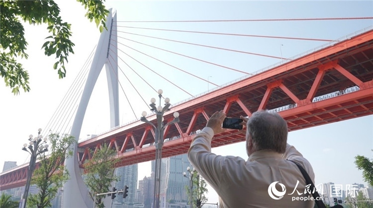 軻寶華“打卡”重慶東水門長江大橋。人民網(wǎng)記者 蘇纓翔攝